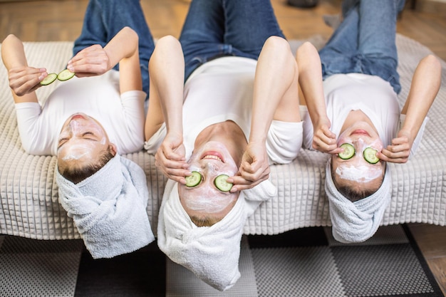 Mother with daughters doing vitamin mask on face