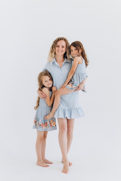 mother with daughters on white background