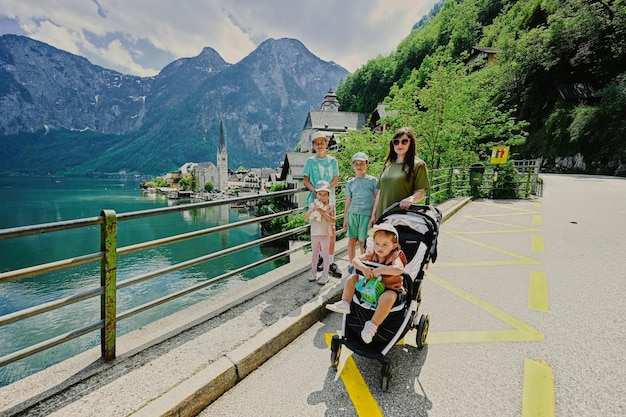 Mother with four kids against beautiful scenic landscape over Austrian alps lake in Hallstatt Austria