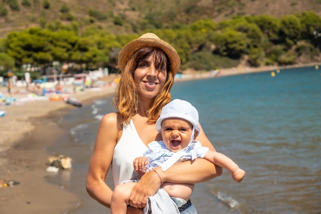 Mother with her baby in Cala Montjoi beach of the Cap Creus Natural Park Gerona