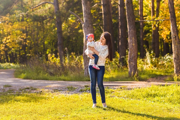 Mother with her baby. Mom and daughter in an autumn park.