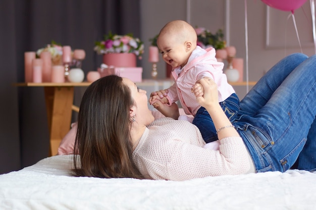 Mother with her little baby in bedroom