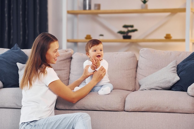 Mother with her little daughter is at home together