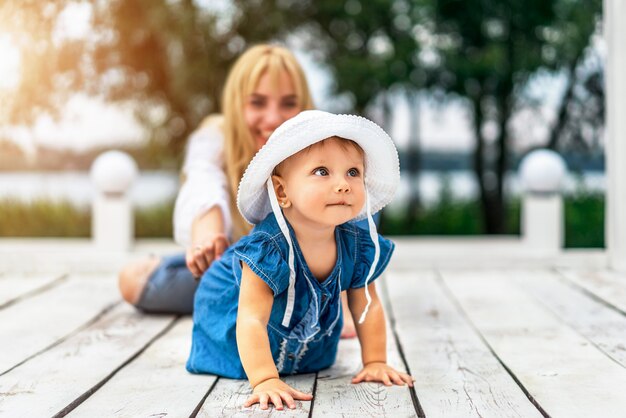 Mother with her little daughter playing outdoor