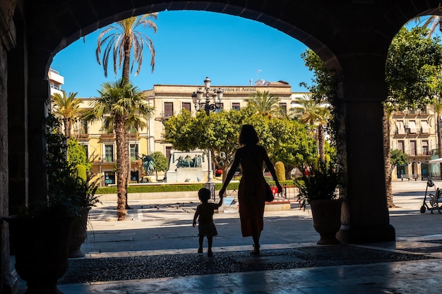 A mother with her son in some arches in Jerez de la Frontera in Cadiz Andalucia