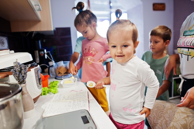 Mother with kids cooking at kitchen happy children's moments