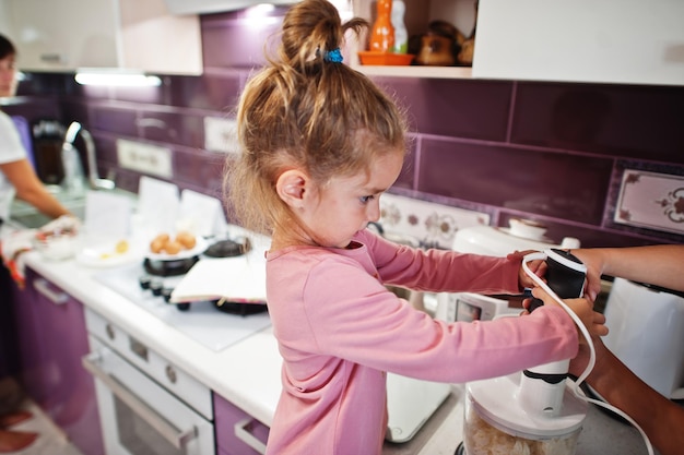 Mother with kids cooking at kitchen happy children's moments