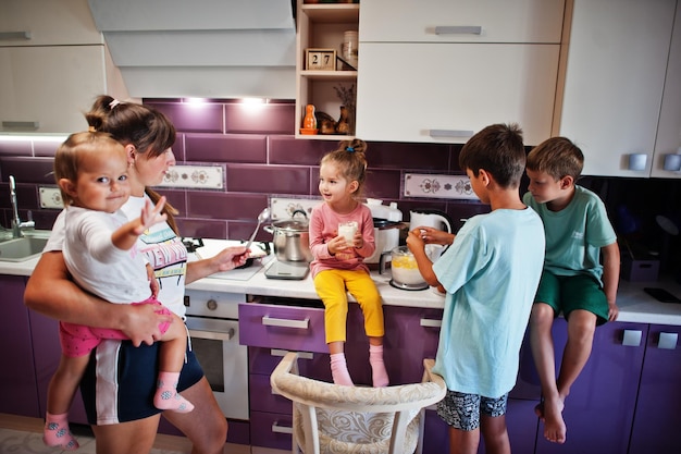 Mother with kids cooking at kitchen happy children's moments