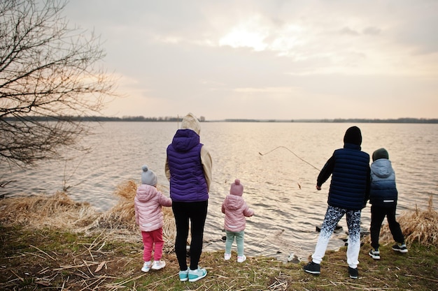 Mother with kids on the shore of the lake