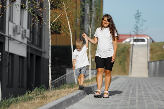 Mother with a little boy walking on the street