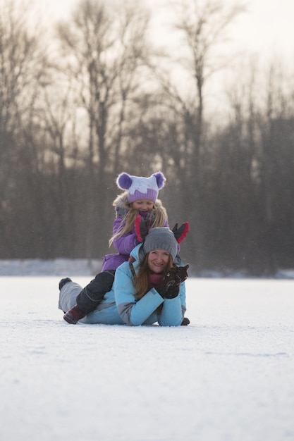 Mother with smiling daughter at the winter walk