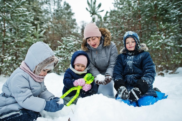 Mother with three children in winter nature Outdoors in snow