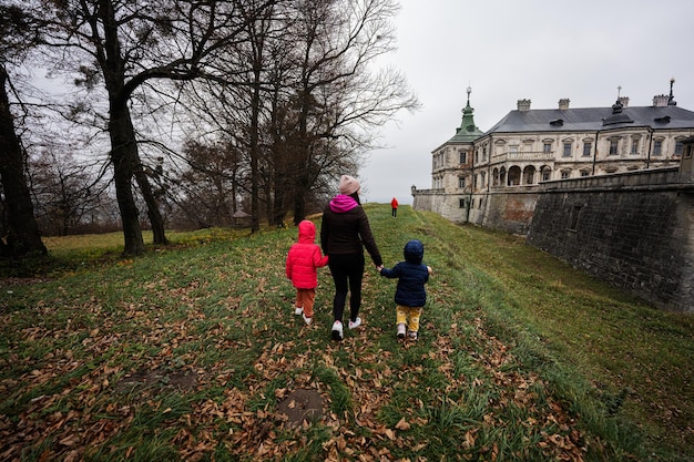 Mother with three kids visit Pidhirtsi Castle Lviv region Ukraine Family tourist