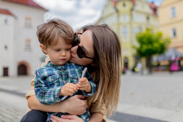 Mother with a toddler boy in old city center. Poland