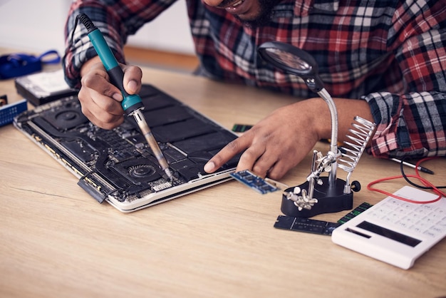 Motherboard working and man hands doing engineer and electricity fix with electrical tools It engineering and electric work of a male fixing microchip and voltage test on a hardware board