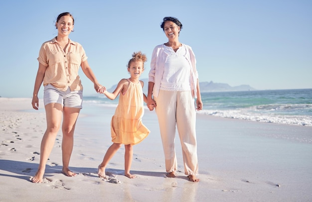 Mothers day mom and child with grandmother at the beach in to celebrate women with children as a happy family Three generations old woman and parent with girl at sea in summer and walking on sand