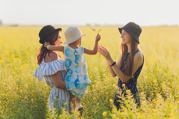 Mothers looking at her daughter and adoring her. Lesbian couple are really happy to adopt a child. LGBT family.