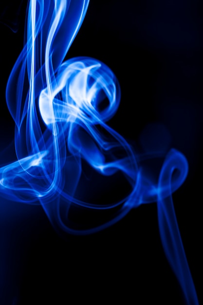 Motion blue smoke on black background.