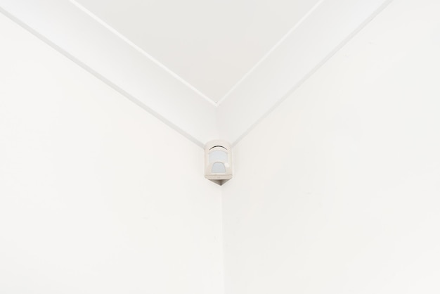 Motion sensor mounted on the corner ceiling