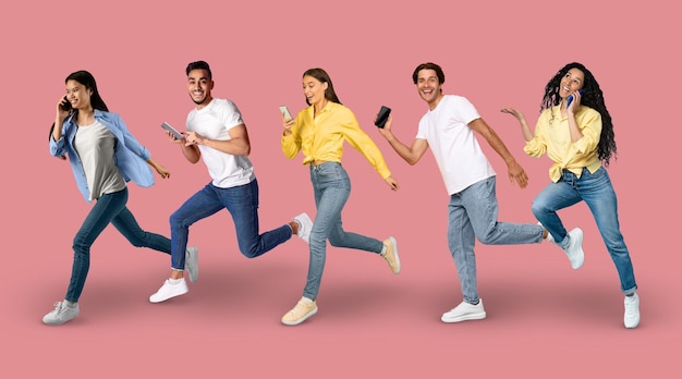 In Motion Shot Of Diverse Multiethnic People Running With Smartphones In Hands