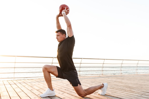 Motivated young sportsman doing exercises