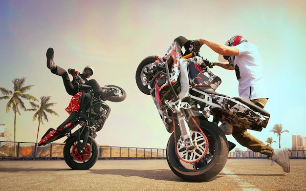 Moto rider making a stunt on his motorbike Biker doing a difficult and dangerous stunt