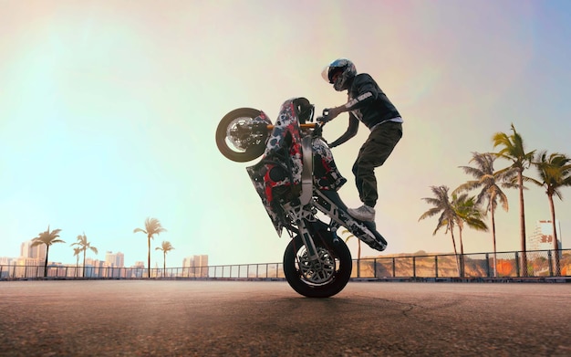 Moto rider making a stunt on his motorbike Biker doing a difficult and dangerous stunt