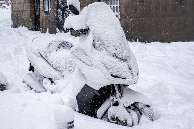 Motorbike covered in snow on a winters day