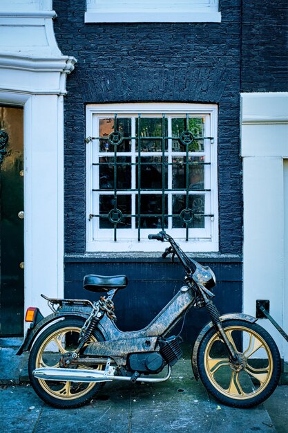 Motorbike parked near old house in amsterdam street