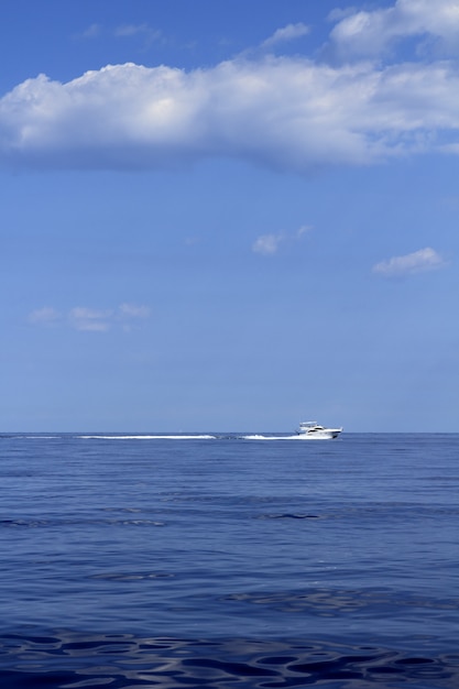 Motorboat fisherboat cruising speed on blue sea