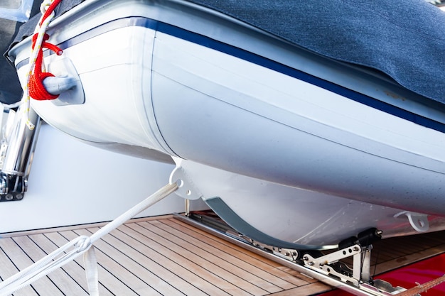 The motorboat is closed and secured on the aft deck of the yacht