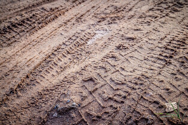 Photo motorcycle and car tire track print on sand or mud with selective focus