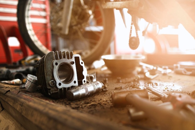 Motorcycle engine repair with softfocus and over light in the background