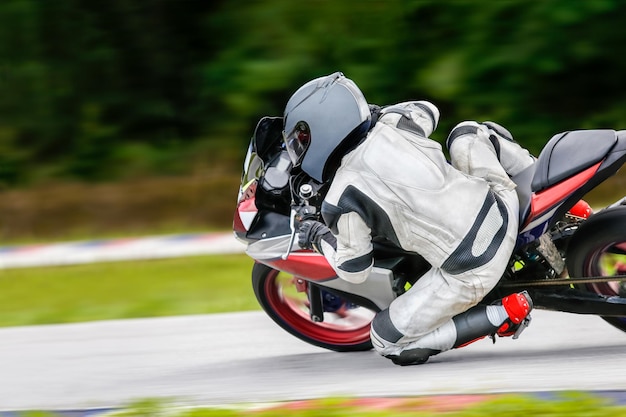 Motorcycle practice leaning into a fast corner on track