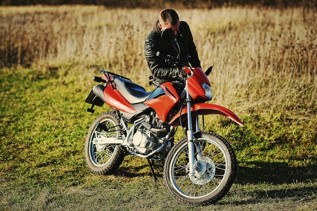 Motorcycle rider stay at sunset with him  bike