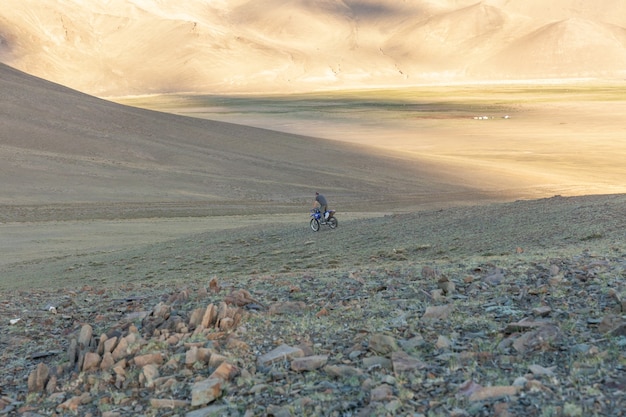 A motorcyclist tries his motorcycle on the hills of Mongolia