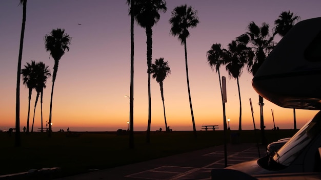 Motorhome trailer caravan for road trip palm trees california beach at sunset