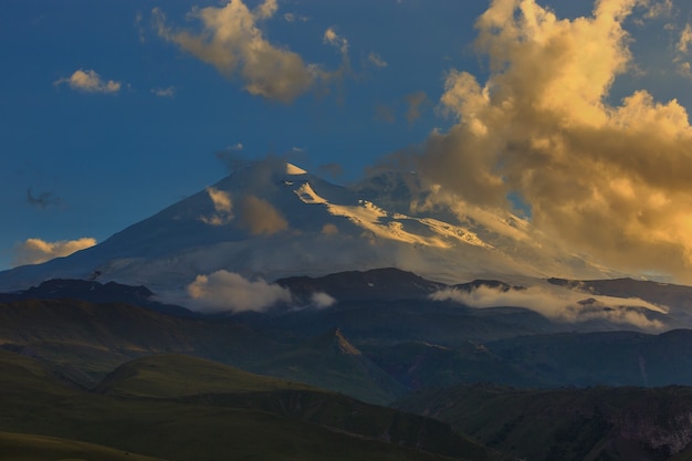 Mount Elbrus during sunset in the rays of the sun. Close-up of a mountain range in the North Caucasus in Russia.