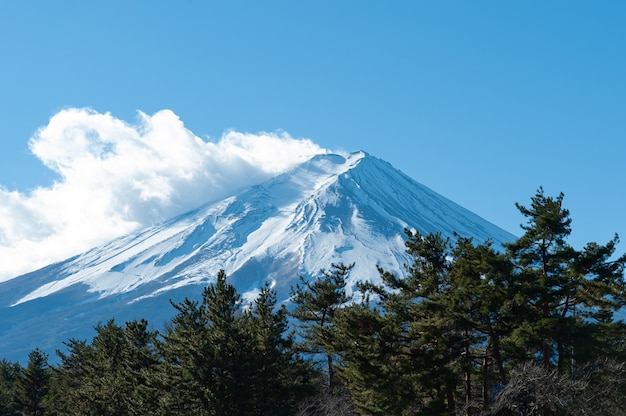 Mount Fuji in winter covered with snow with beautiful blue sky and white cloud