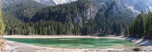 mountain backdrop reflecting in crystal waters of Tovel lake Ville d'Anaunia Trentino Italy