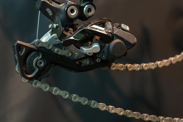 Mountain bike in the workshop Bicycle rear derailleur closeup on a black background The concept of cycling improves health and mood