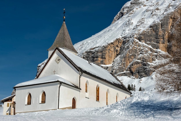 mountain church in winter on sunny day