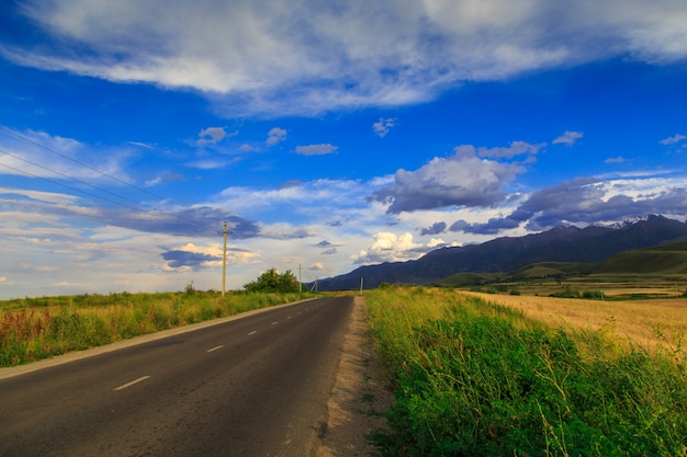 Mountain country road among green hills