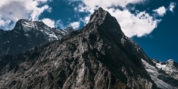 Mountain glacier, panoramic view. Stunning mountain view, banner. Magnificent view of the steep slopes on a sunny winter day. Mountain peak, banner. Copy space