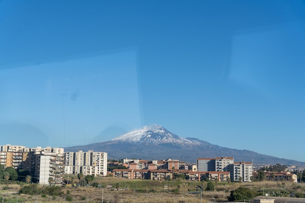 A mountain is visible in the distance behind a city