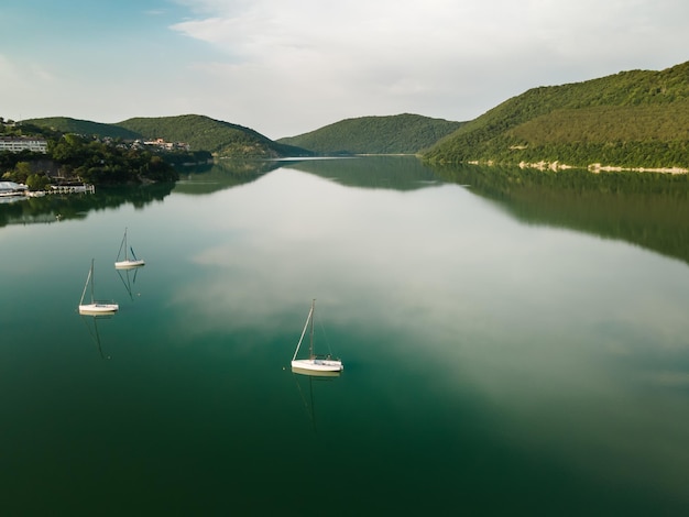 Mountain lake with turquoise water and yachts Abrau lake in AbrauDurso village Russia