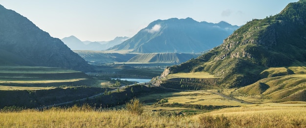 Mountain landscape in evening light valley with river