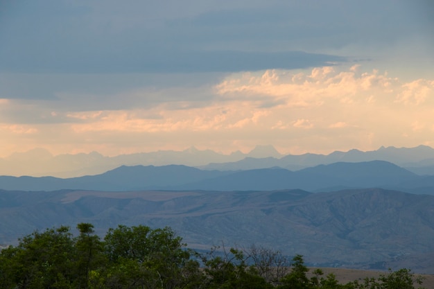 Mountain landscape in Georgia, clouds and blue sky. Mountain range. sunset time.