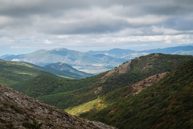 Mountain landscape, green hills on a sunny summer day, cloudy