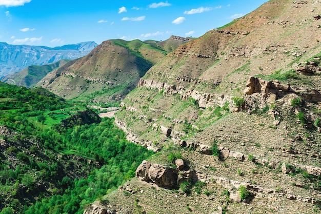 Mountain landscape of the North Caucasus rocky cliffs over a green valley